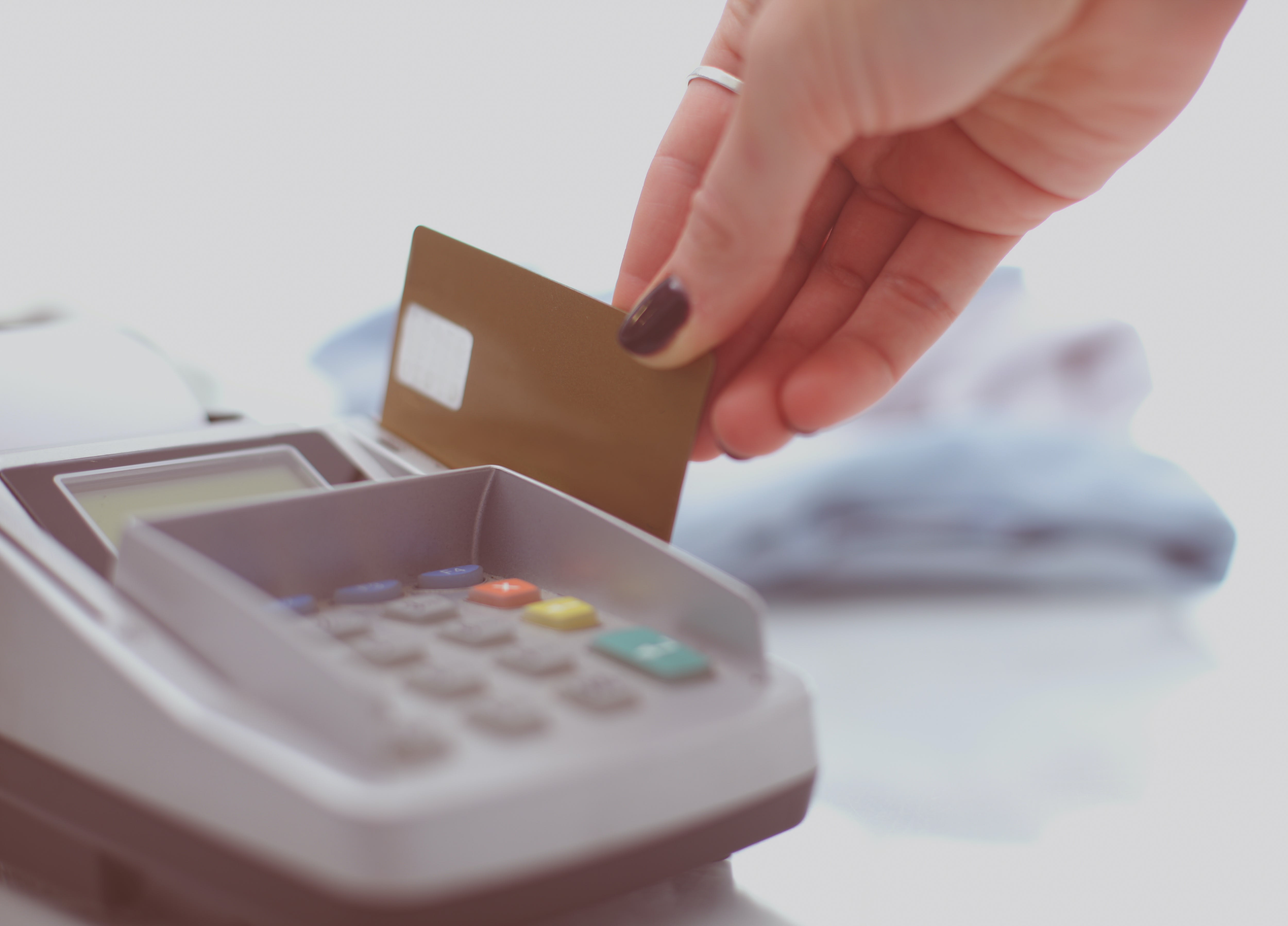 A woman swiping a card in a card reader